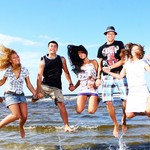 Happy teenagers playing at the sea