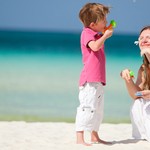 Mother and kids having fun on beach