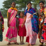 Indian women in brigt traditional sari in the Goa beach